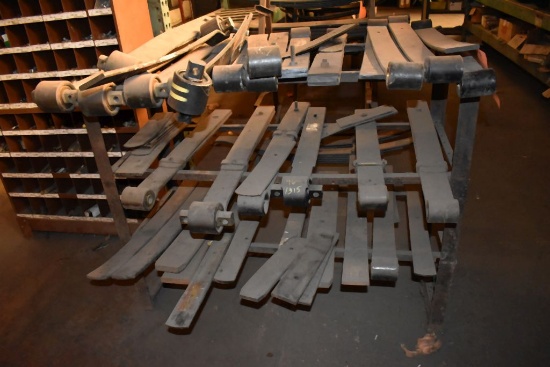 SMALL METAL STAND WITH ASSORTED LEAF SPRING PARTS