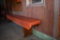 LONG WOODEN BENCH WITH ORANGE VINYL PADDED SEAT WITH