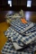 STACK OF BLUE AND WHITE CHECKERED TABLE CLOTHS AND