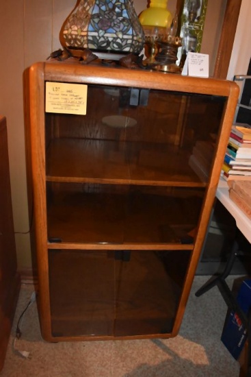 BROWN WOOD CABINET W/GLASS DOORS ON WHEELS,