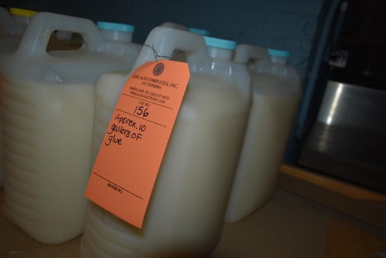 APPROX. 10 GALLONS OF GLUE IN FOUR CONTAINERS