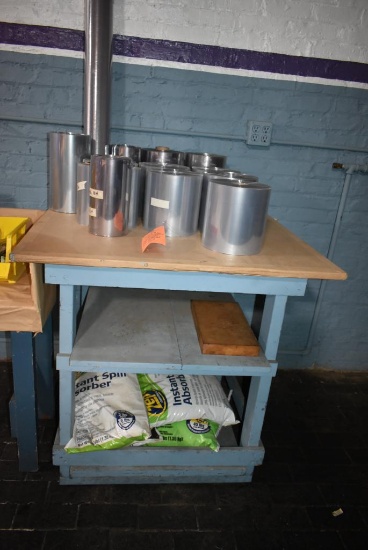 WOODEN TABLE WITH CONTENTS; ROLLS OF PLASTIC & ZEP INSTANT SPILL ABSORBER