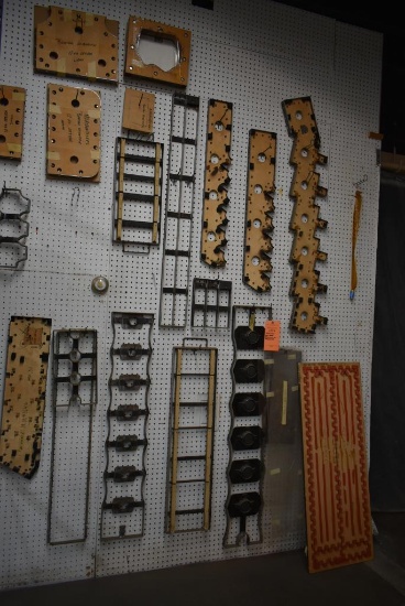 ASSORTED DIES HANGING ON PEGBOARD