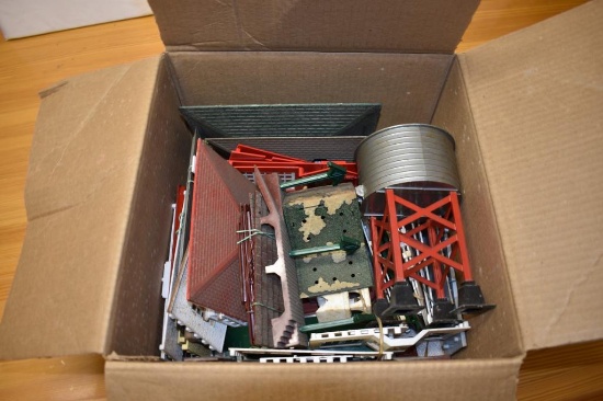 Box with miscellaneous train track decorations, disassembled buildings, water tower, Etc