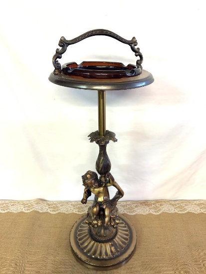 ANTIQUE ASHTRAY ON STAND W/GLASS ASHTRAY APPROX 24"TALL, CHERUB METAL BASE
