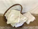 LOT OF VINTAGE TABLECLOTHS WITH BASKET