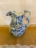 BLUE 7 WHITE CERAMIC PITCHER, FEATURES RAISED FLORAL DESIGN, 10 1/2
