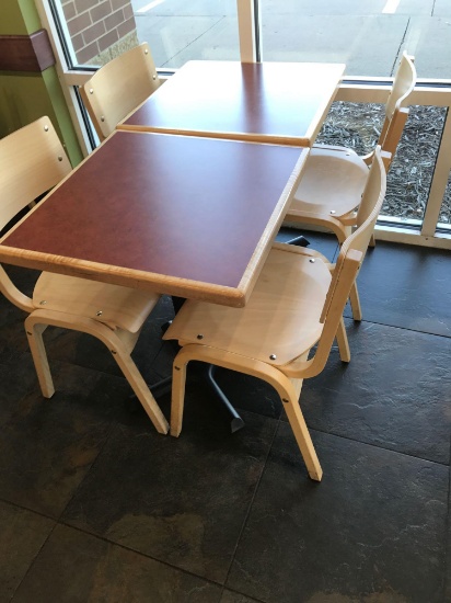 Two tables with four chairs