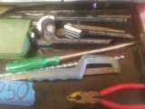 Tools in drawer: saw, screw driver, socket set, etc