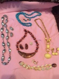 Large costume jewelry and earrings to match