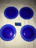 Set of four small blue glass plates