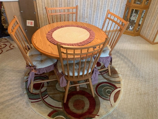 Nice light oak 40? table and 4 chairs, with pads and carpet under table.