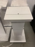 White Podium that is compatible with a Mac computer slides in front, spot for keyboard and mouse