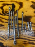 Various brands of socket extensions and a breaker bar