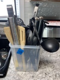 Container full of serving tongs spatula?s soup ladles pasta spoons plus