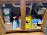 Cabinet full of trash bags dishwasher tablets cleaning supplies