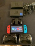 Nintendo Switch gaming system with 2 docking stations and 2 additional remote controls. Like new!