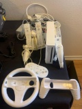 Nintendo Wii with remotes gun attachment steering wheel attachment additional controller and all