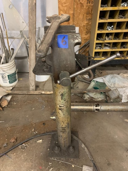 Vice on stand is bolted to the ground with heavy duty crescent wrench