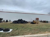 Tires pallets 50 gallon drums tank holders all items on the side of the building