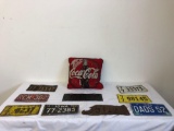 Miscellaneous plates and Coca-Cola throw pillow