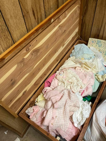 Vintage cedar trunk filled to the brim with beautiful baby girl clothes