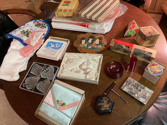 lot of vintage placemats, glassware, fishing line, puzzles, jewelry box with marking