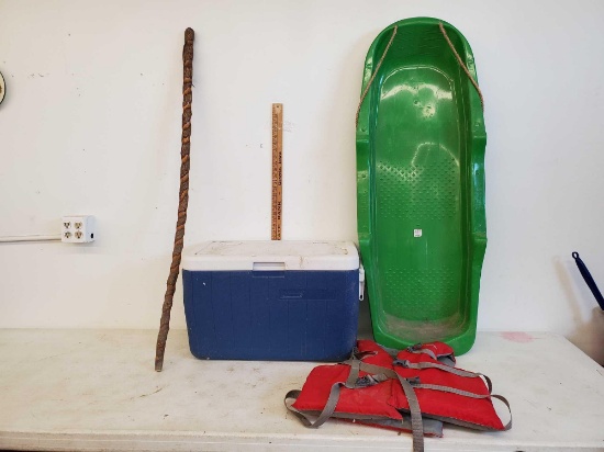 Green Snow Sled, Coleman Cooler, Walking Stick, Life Jacket