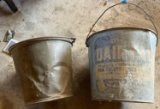 Two large galvanized or a metal buckets one says dairy maid for calves and pigs