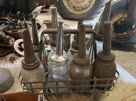 vintage oil fillers( some on ball jars) in crate