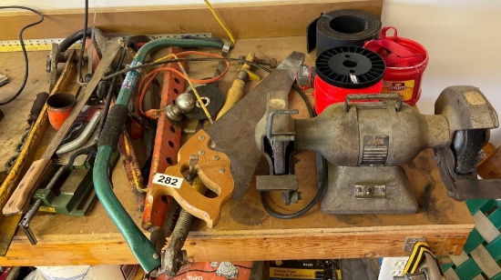 Miscellaneous tools, hitch, bench grinder, and more on top of bench