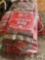 Several bags of red mulch