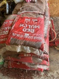 Several bags of red mulch