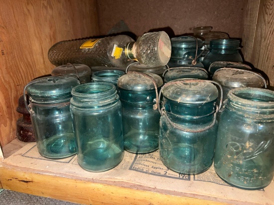Blue canning jars and butter churn- bottom shelf