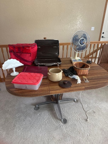 lot of miscellaneous items, table, fan briefcase cooler