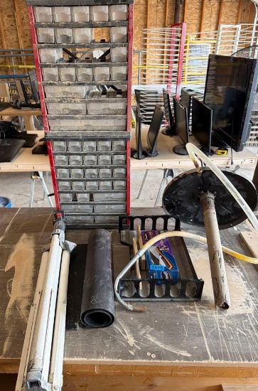 lot of bucket pump, parts bin with some inside, tripod