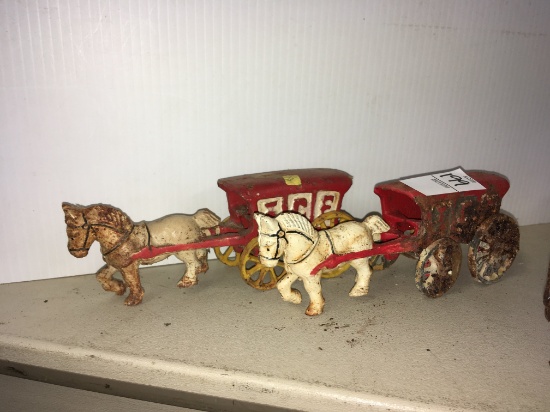 Two cast iron horse and wagon's