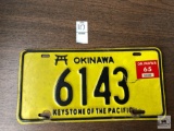 Vintage Okinawa license plate with 1965 registration sticker