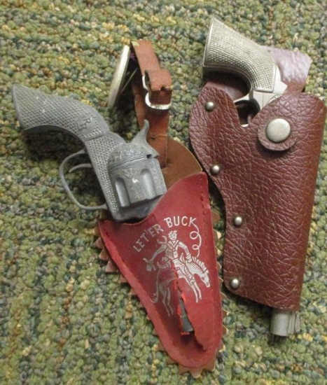 2 SMALL TOY HOLSTERS WITH GUNS