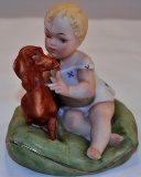 Porcelain little girl with Dachshund dog on pillow