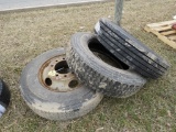 3 truck tires and 2 rims