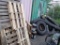 Large Wall Lot of Fencing, Tires, and Pallets