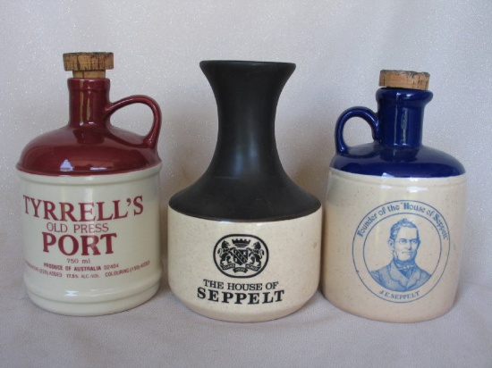 Eight vintage pottery port / whiskey jugs