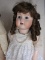 Four reproduction porcelain dolls:- Jumeau long face Bebe 43cm on compositi