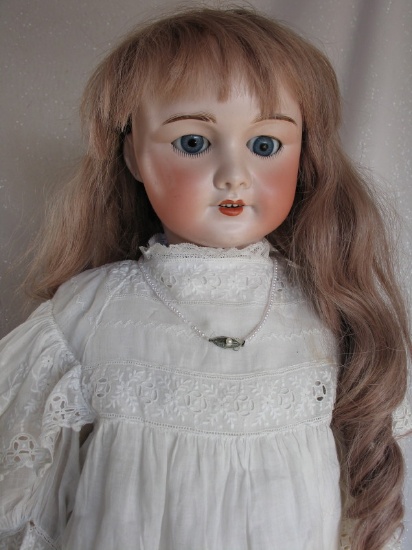 French S.F.B.J. 301 Bebe oily bisque 25" (64cm). Blue glass sleeping eyes,