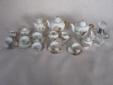 Mixed china miniature tea sets:- three on trays, and two other sets with fl