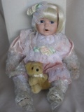 Four boxed porcelain dolls:-Heritage Heirloom MIB blonde Baby in pink satin