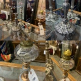 Ornate silver plated candle sticks and copper antique oil lamp