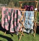 TWO WOOD DRYING RACKS WITH BLANKETS