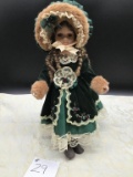 VINTAGE PORCELAIN DOLL WITH GREEN DRESS